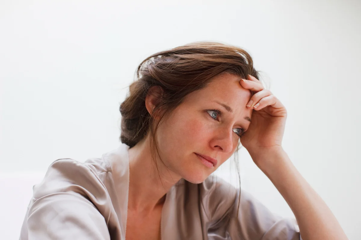 Young woman crying and grieving over the loss of a loved one